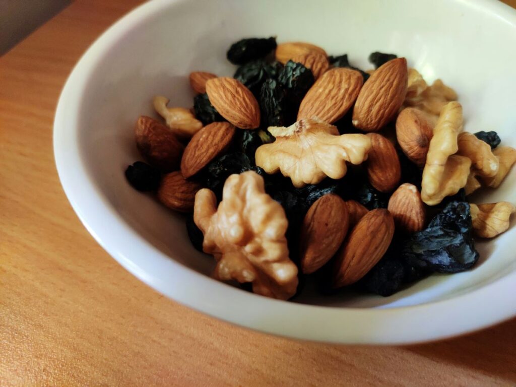 Bowl of unsalted nuts including walnuts and almonds is a healthy snack