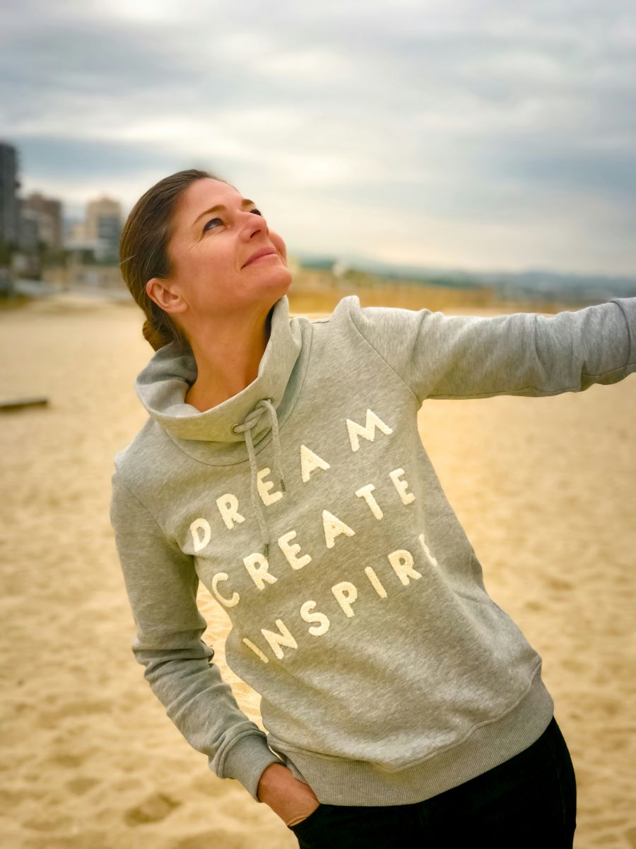 Mom wearing sweatshirt that says Dream, Create, Inspire