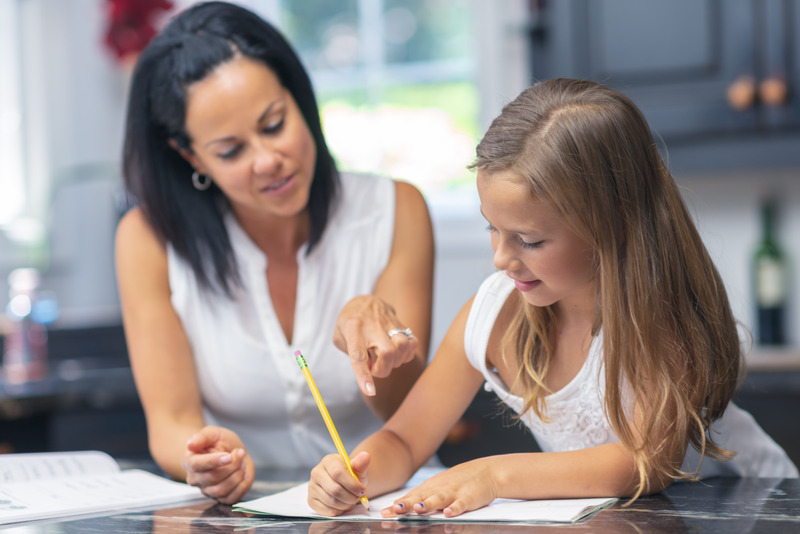 Mom helping her teen daughter with homework