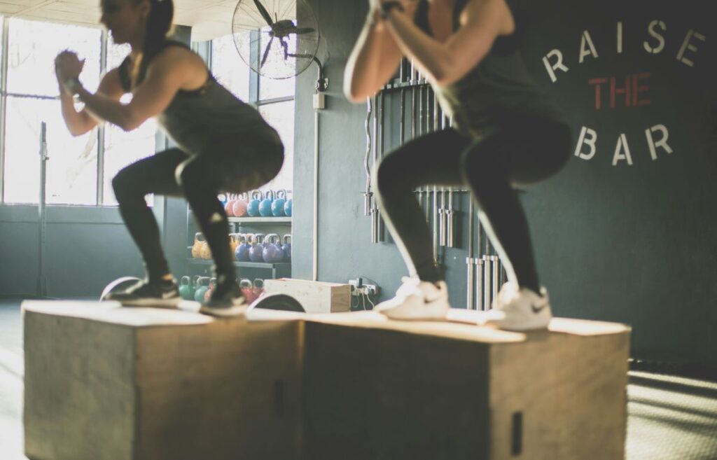 Women doing squat at a gym