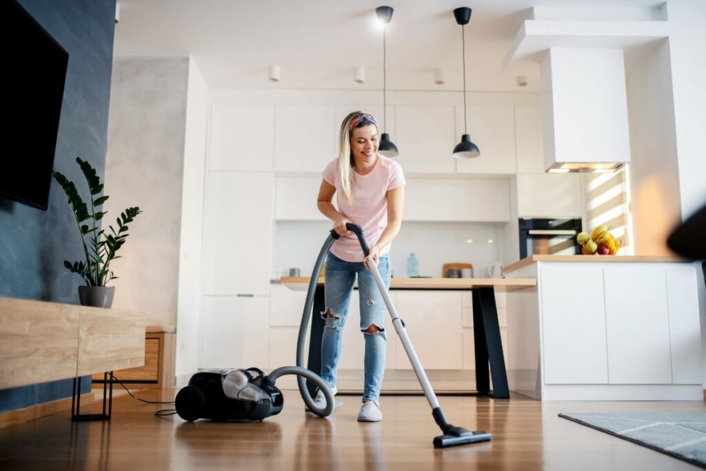 Woman vacuuming her home