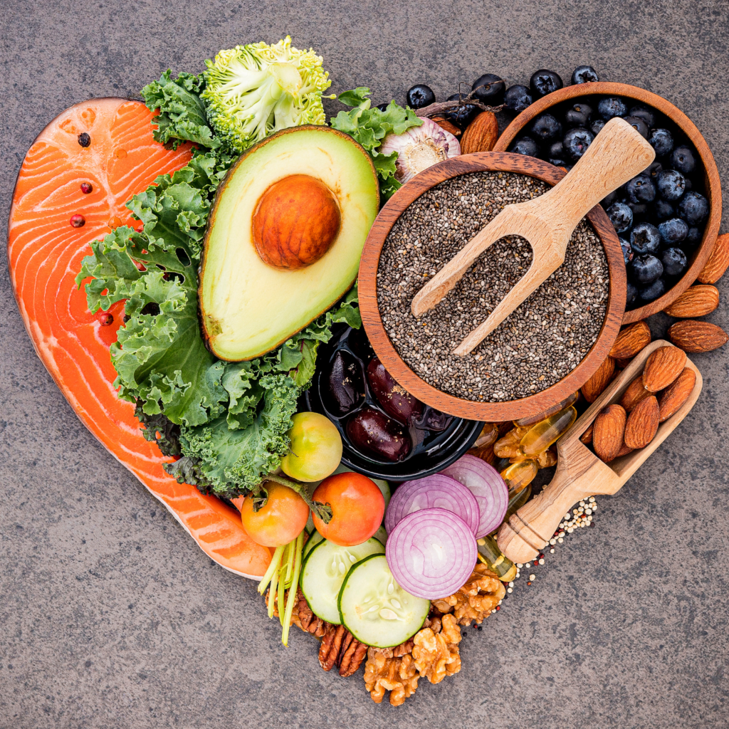 A selection of heart-healthy foods, including salmon, nuts, and avocado, which support heart health during menopause.