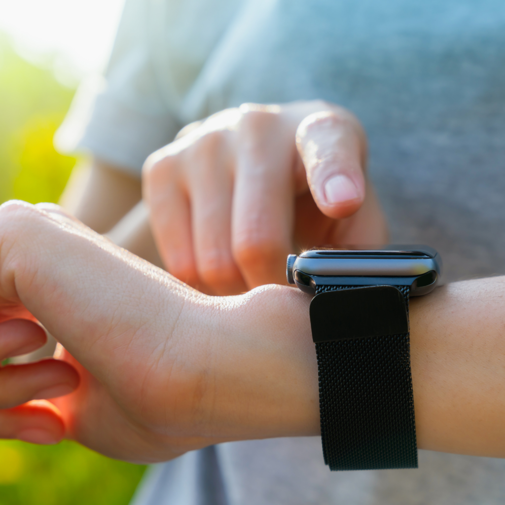 A woman checking her smartwatch and tracking activity levels, an important step for maintaining heart health during menopause.