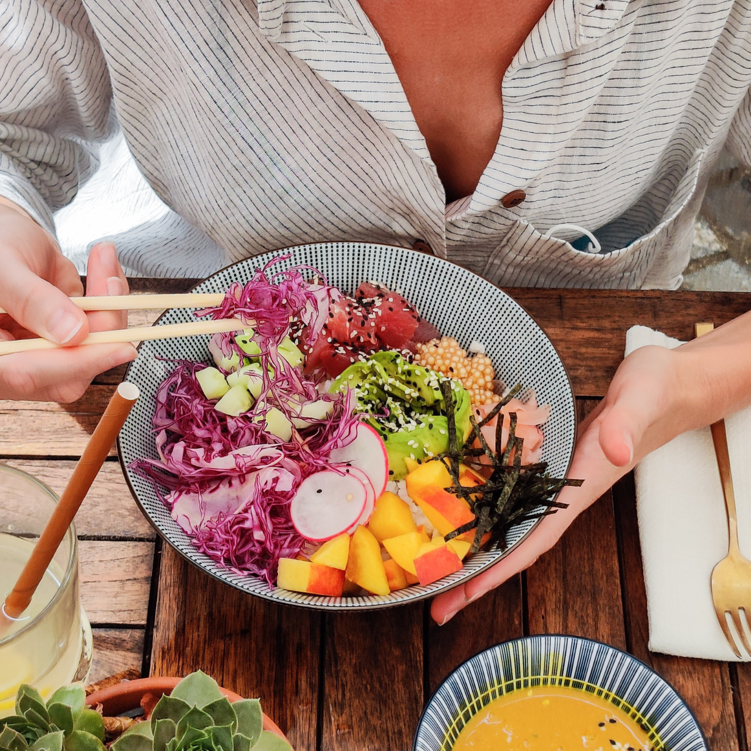 A woman enjoying a plate of colorful vegetables, highlighting the importance of proper nourishment during fasting.