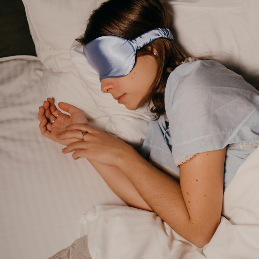 A midlife woman sleeping peacefully, symbolizing the importance of sleep for hormone and stress recovery