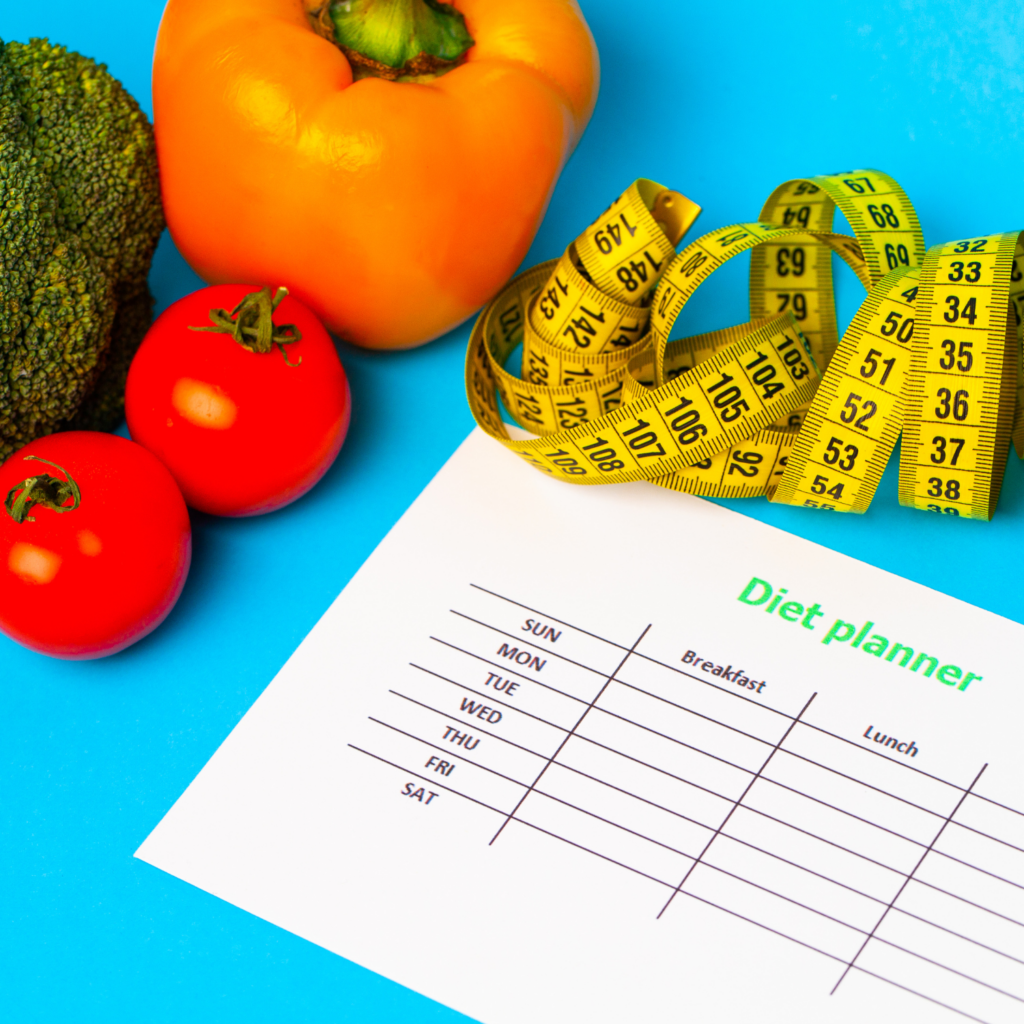 A diet planning sheet with vegetables and a tape measure, representing outdated strategies for midlife weight gain