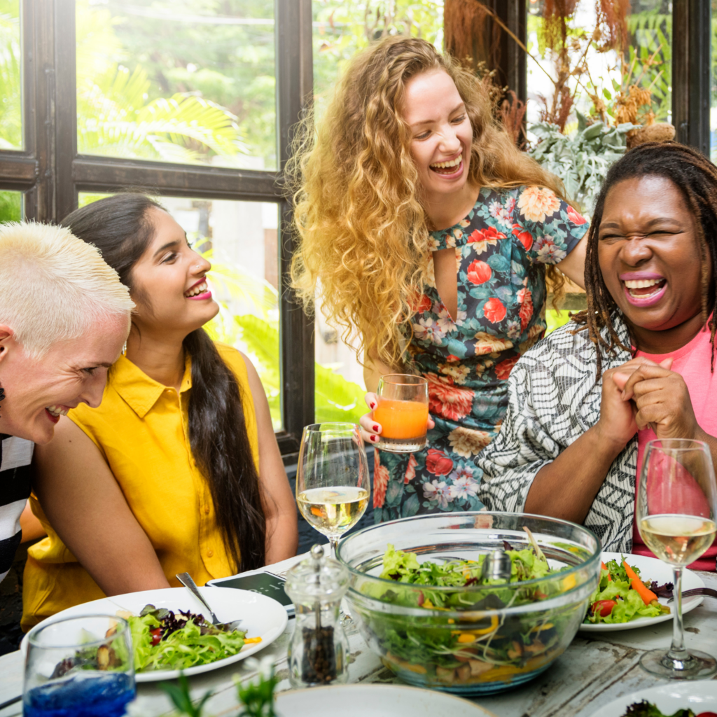 Midlife women enjoying a healthy meal together, reflecting a sustainable approach to fasting in midlife
