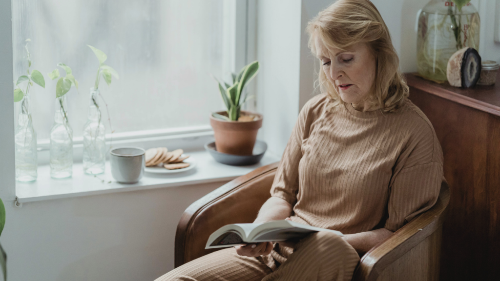 Woman over 50 reading at home and learning about hormone therapy and menopause health options