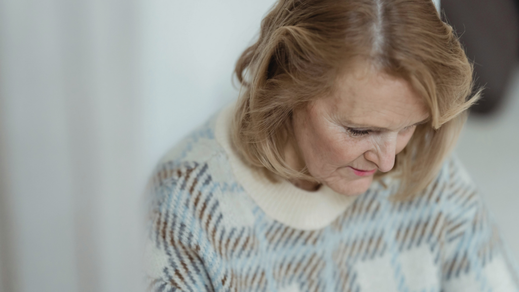 Midlife woman researching menopause symptoms and hormone therapy treatment options at home