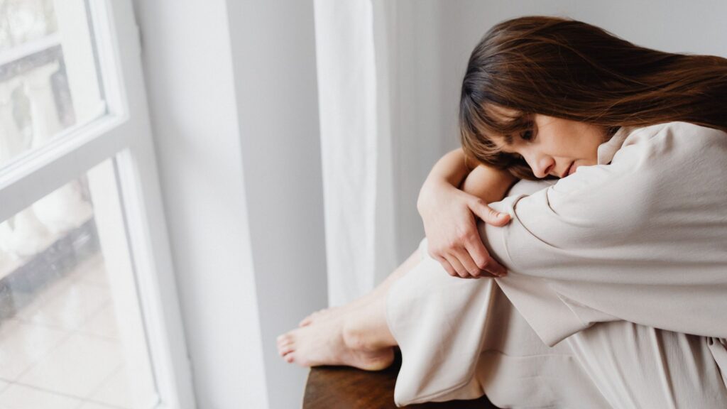 Midlife woman feeling overwhelmed by low mood and emotional changes during perimenopause