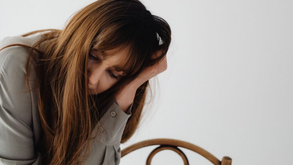 Midlife woman feeling emotionally exhausted and struggling with hormone-related fatigue